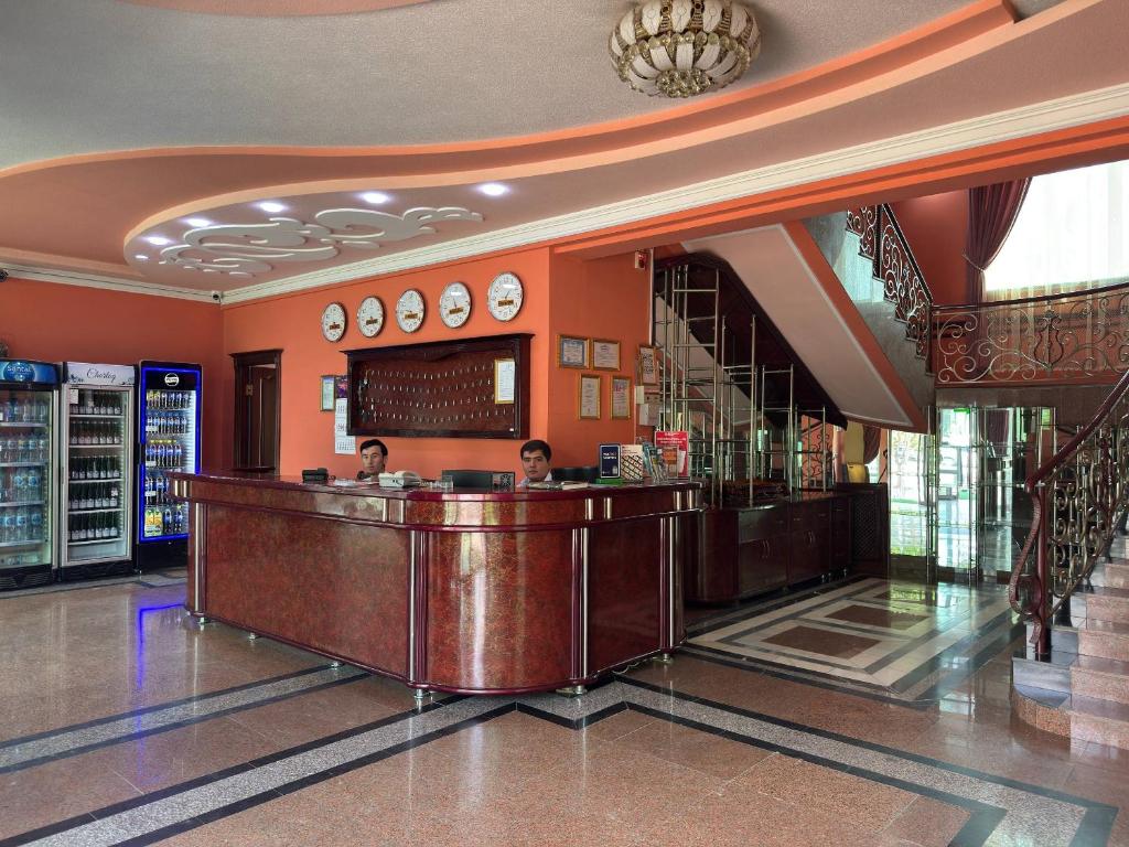 two people sitting at a bar in a lobby at Turkiston Hotel in Namangan