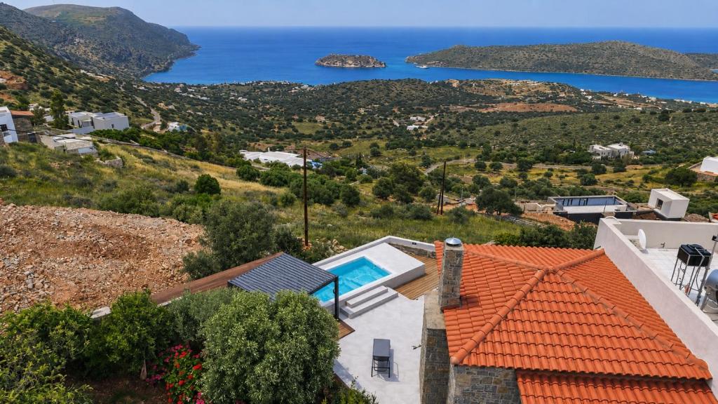 a view of the ocean from a house at Aurora Spinalonga Garden Villa with Jacuzzi Pool in Chavgas