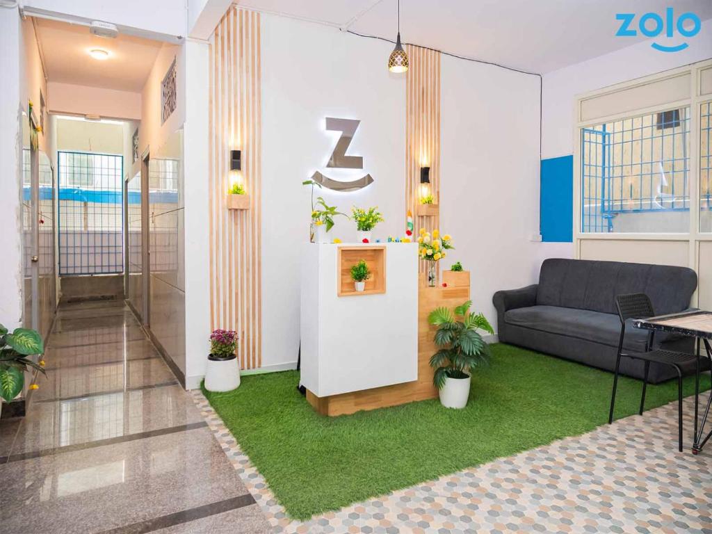 a living room with a couch and a table at Z Express Leela in Bangalore