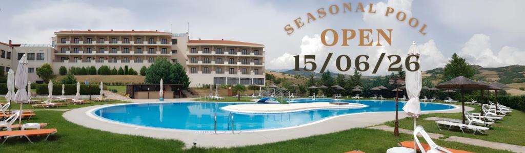 a hotel with a swimming pool in front of a building at Siris Hotel in Serres