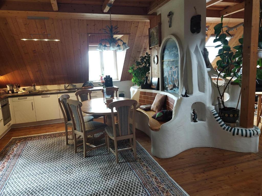 a living room with a table and a kitchen at Ferienwohnung Jauk in Gleinstätten