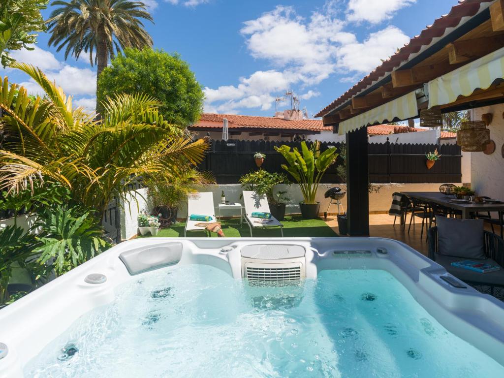 a hot tub on the patio of a house at Oasis Beach Holiday Home with jacuzzi in Playa del Ingles