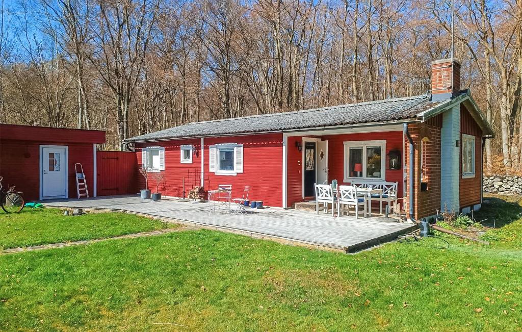 a red tiny house with a porch and a deck at Cozy Home In Sölvesborg With Wifi in Sölvesborg