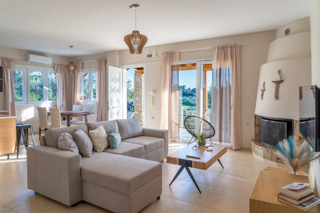 a living room with a couch and a fireplace at Family Heritage Homes- Skiathos in Skiathos