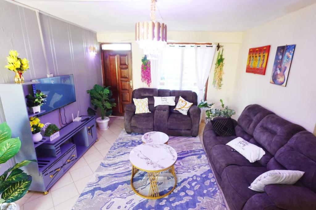 a living room with two couches and a table at The Nest Apartment Darad in Ukunda Airport