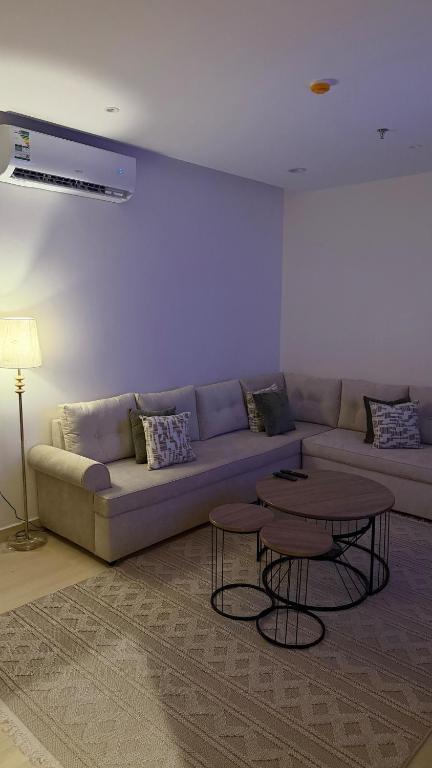 a living room with a couch and a table at Apartment in Al Kharj