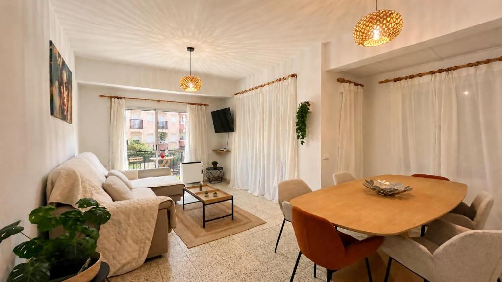 a living room with a table and a couch at APARTAMENTO SOL Y PLAYA in Santa Pola
