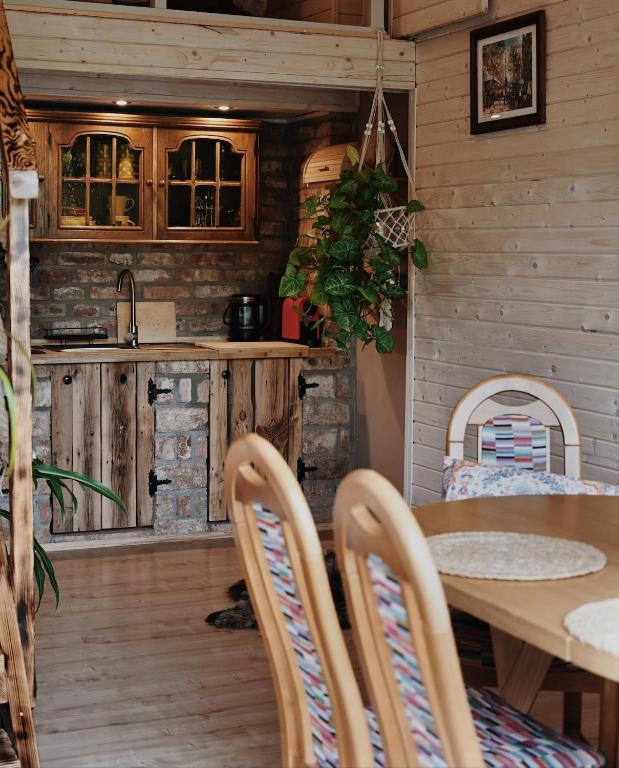 a kitchen and dining room with a table and chairs at ojcowska stodoła in Wola Kalinowska
