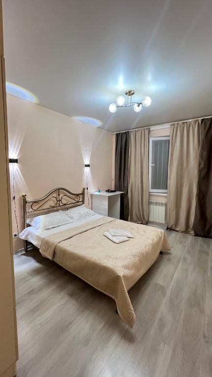 a bedroom with a large bed in a room at Daraboz in Almaty