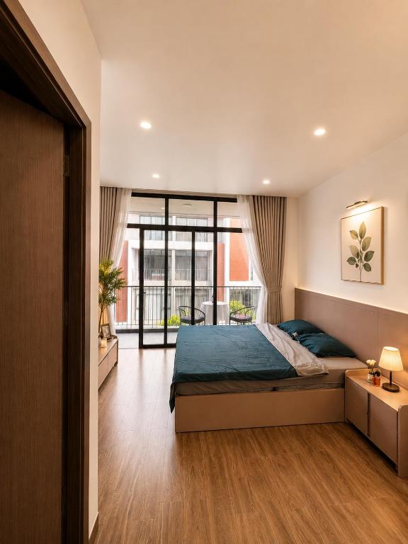 a bedroom with a bed and a large window at U-ViVu Homestay Ocean Park 3 Hưng Yên in Ðình Loan