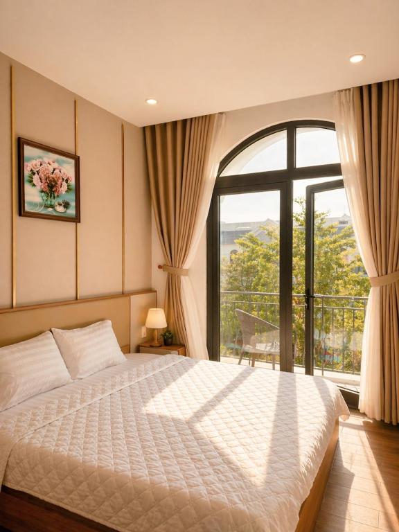 a bedroom with a bed and a large window at SOLÉRA 2 Homestay in Phú Quốc