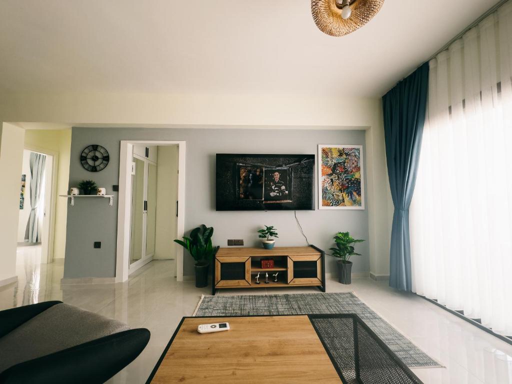 a living room with a couch and a table at Luxury 2 Bedroom Apartment in Caesar Resort in Iskele
