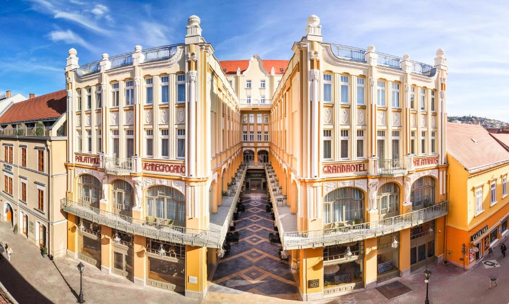 an aerial view of a building with yellow at Palatinus Grand Hotel in Pécs