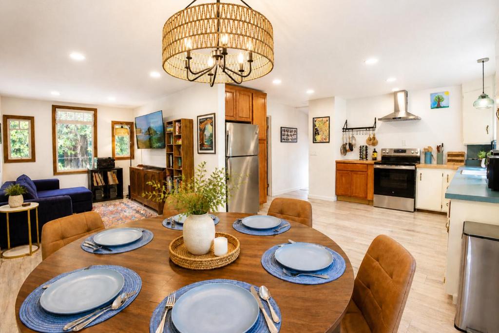 a kitchen and living room with a wooden table and chairs at Boho Burrow in Monte Rio