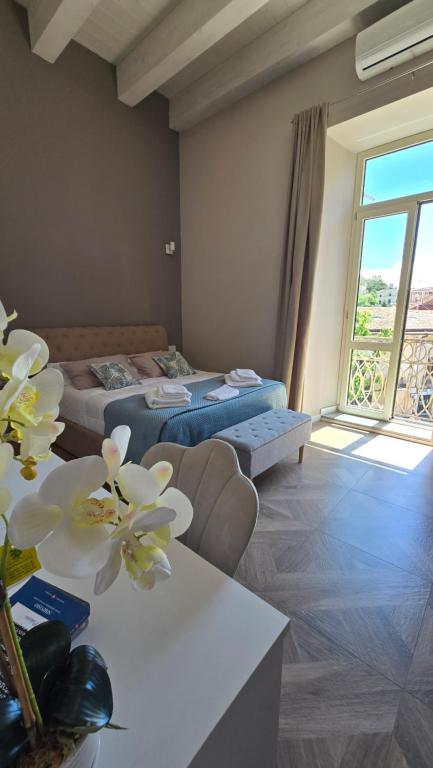 a hotel room with two beds and a window at Numistrano Room in Lamezia Terme