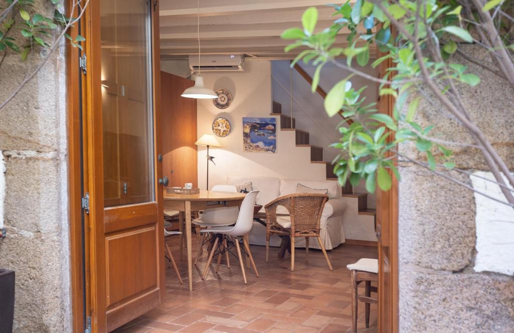 a room with a table and chairs and a staircase at LETS HOLIDAYS NICE HOUSE CLOSE to the CASTLE in Tossa de Mar
