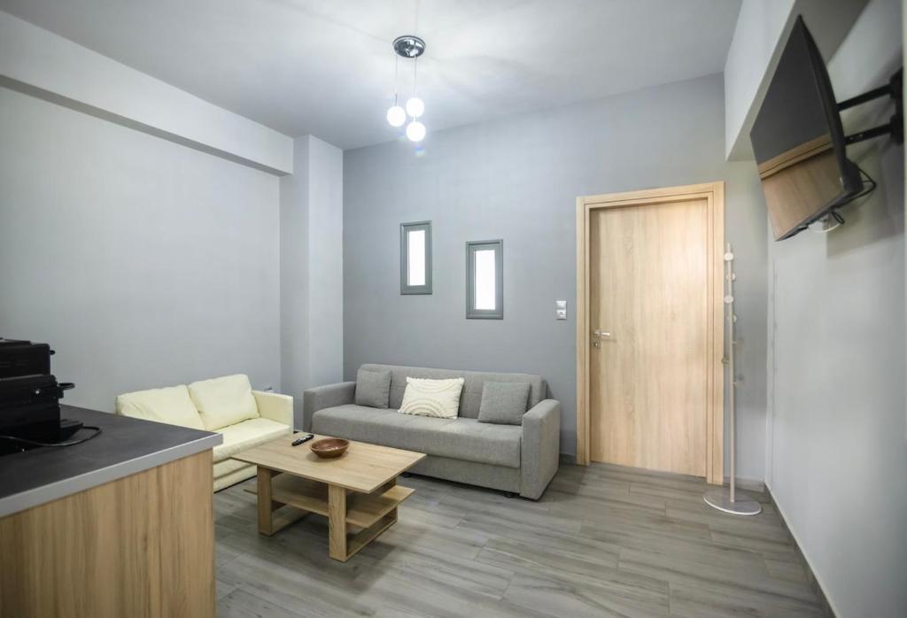 a living room with a couch and a table at Sea Breeze Stay 1 in Salamina