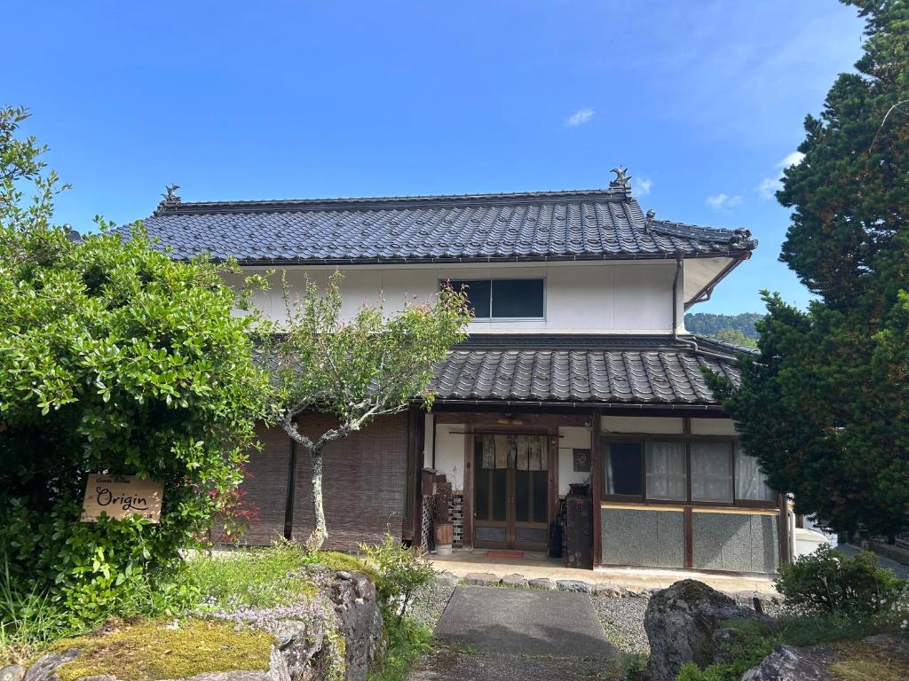 a small house with a sign on the side of it at Nagomi Yado Origin in Ayabe