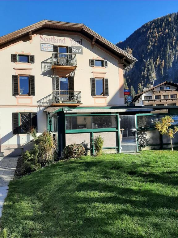 a building with a green lawn in front of it at Boardwalk center in Mayrhofen