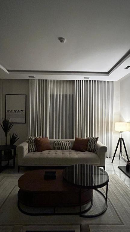 a living room with a couch and a table at M Residence in Dhahran