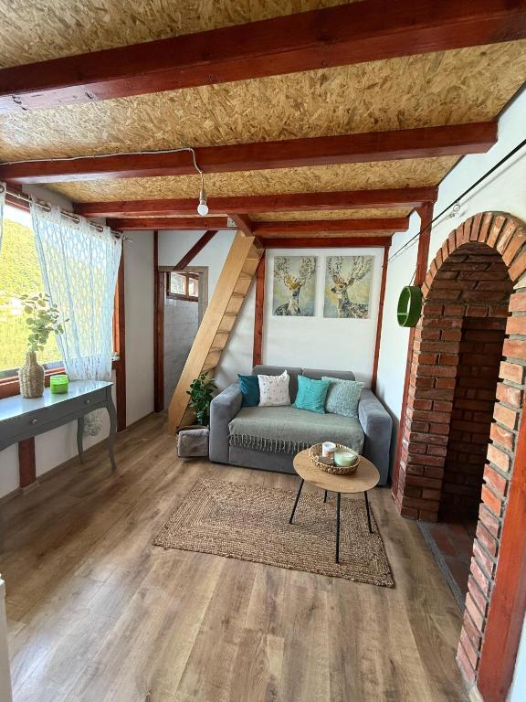 a living room with a couch and a table at Zmajeva Kuca in Mali Zvornik