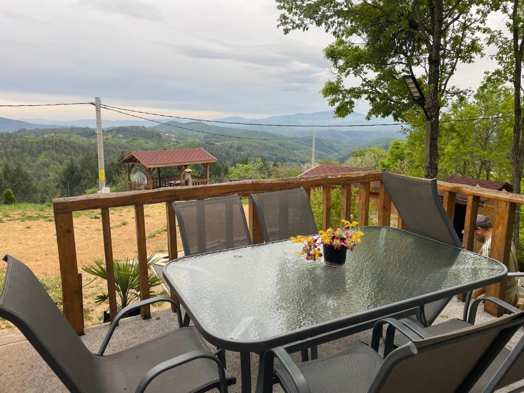 a table and chairs on a deck with a view at Villa Elias in Zlatograd
