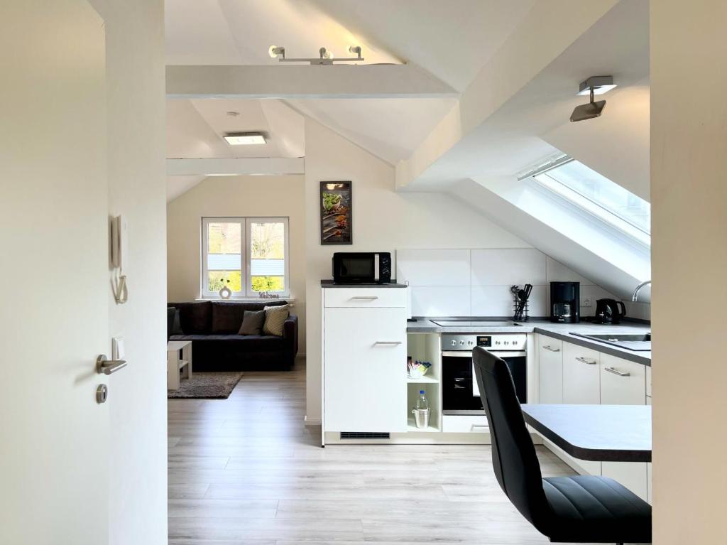 a kitchen and living room with a table and chairs at Fewo Diemelsee 5 in Heringhausen