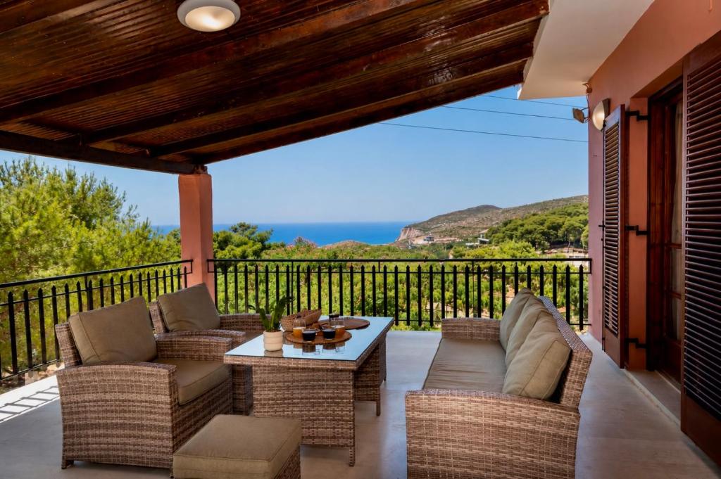 a patio with couches and a table on a balcony at Villa Apelati in Keri