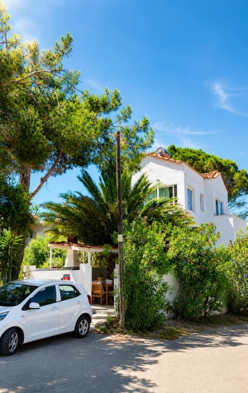 a white car parked in front of a house at Spitaki Almyrida in Almyrida