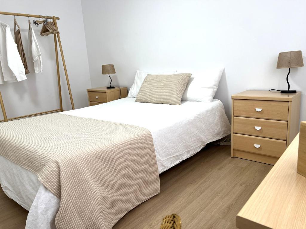 a bedroom with two beds with white sheets and a dresser at 3 Bed Flat - Sleeps 5 - Wifi in Bellreguart