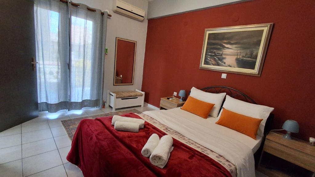 a bedroom with a large bed with orange walls at The Best Choice in Preveza