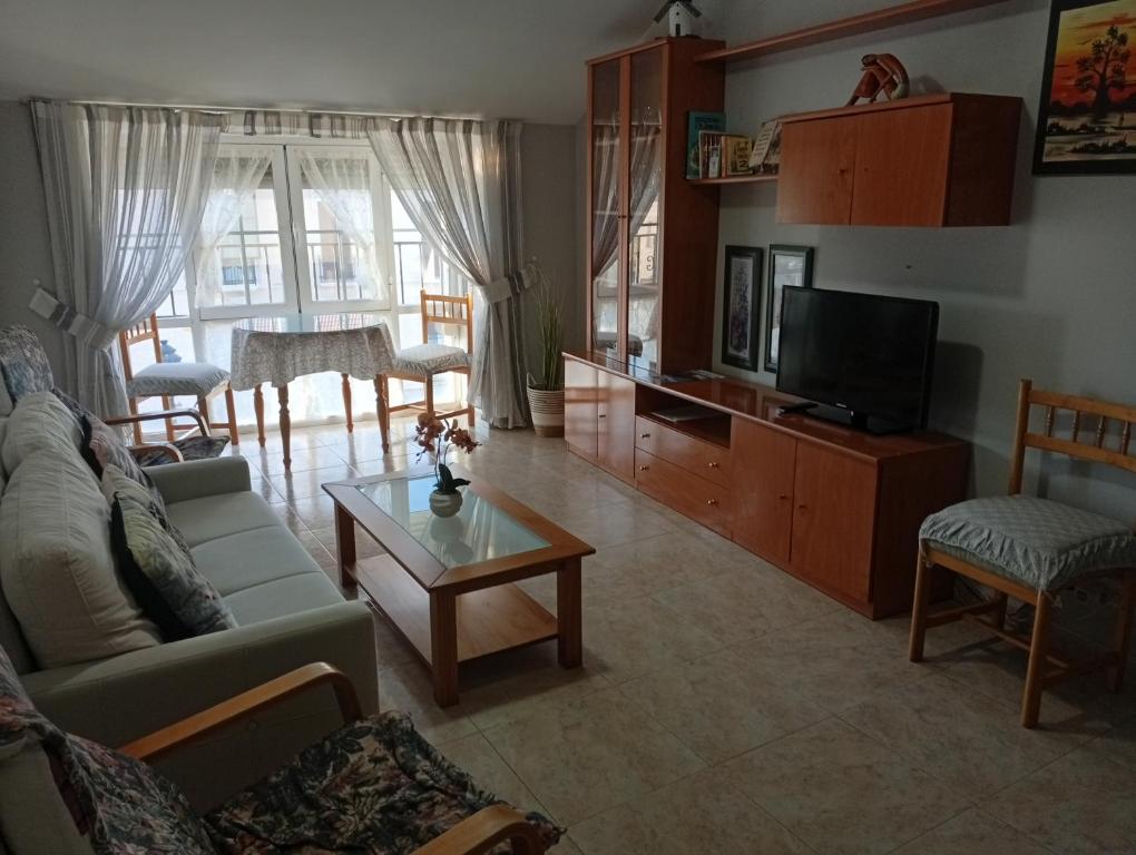 a living room with a couch and a tv at Apartamento manchego Macrina in Villarta de San Juan