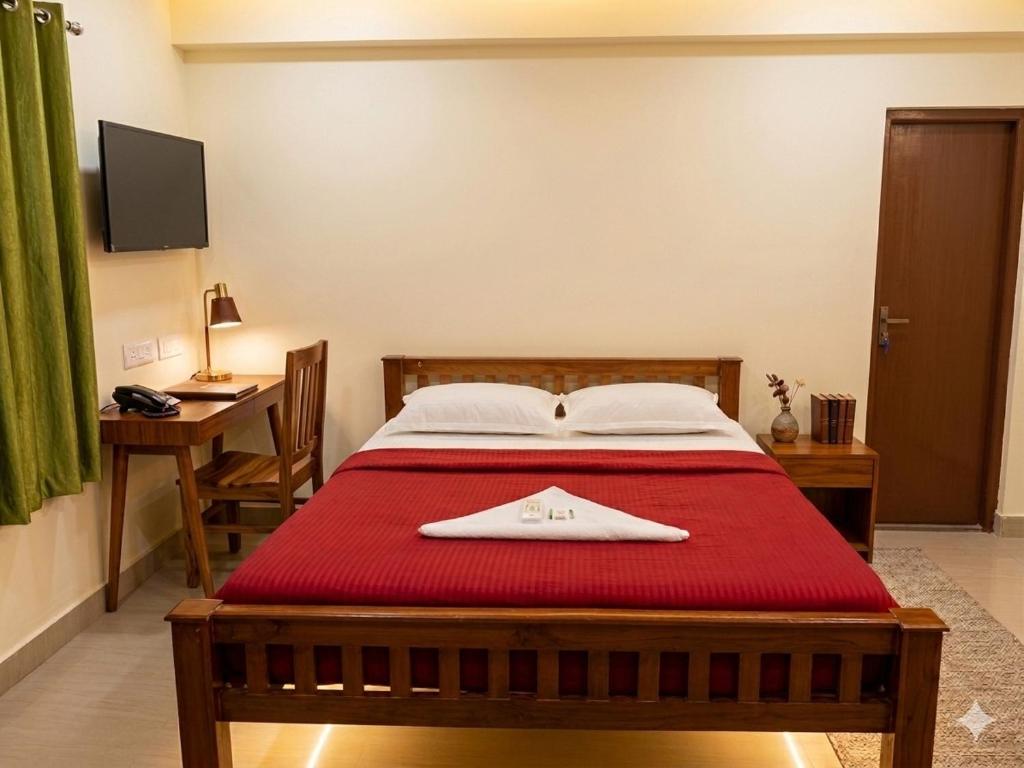 a bedroom with a bed with a towel on it at S P Nettoor in Cochin