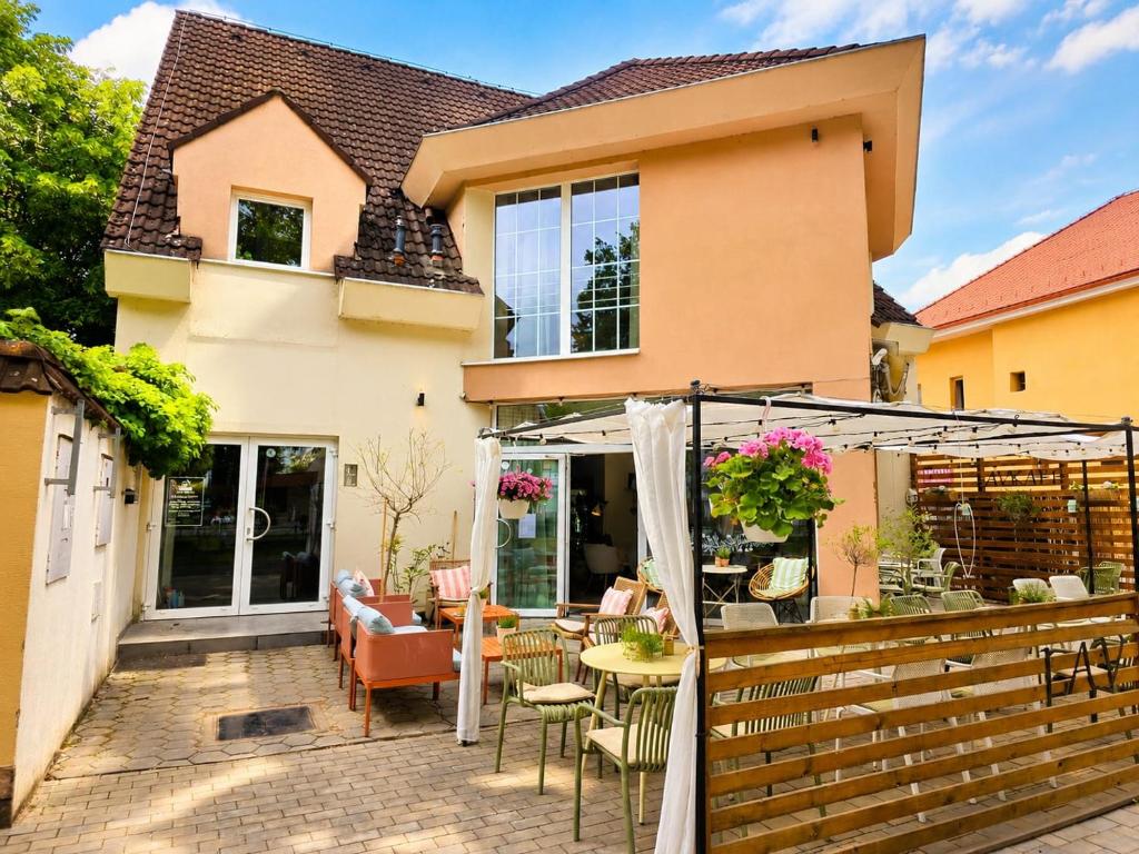 a house with a patio with a table and chairs at Apartmány Bojnický Vínny Dom in Bojnice