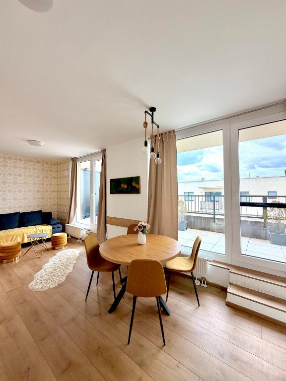 a living room with a table and chairs and a couch at Strešný Aparmán Pri Mlyne in Skalica