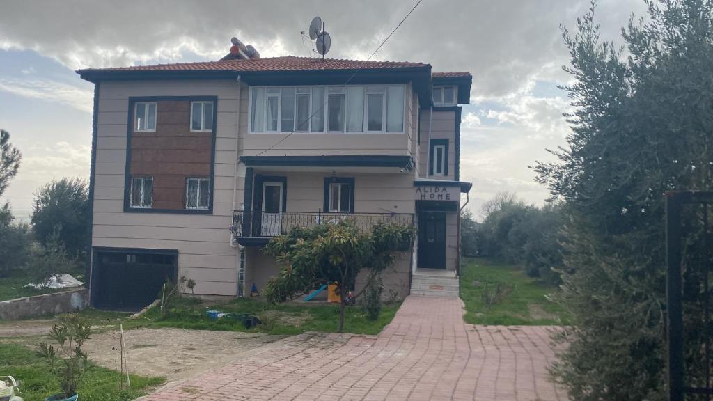 a house with a brick driveway in front of it at Alida Home Pamukkale in Pamukkale