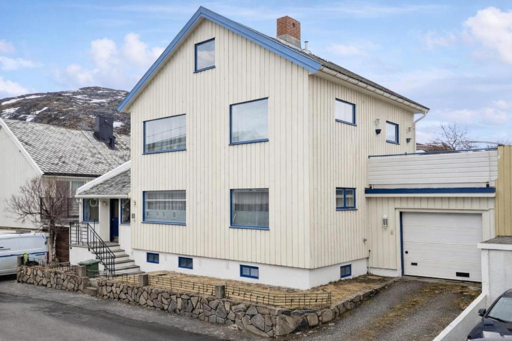 a white house with a garage at Homestay Hammerfest - Central - Lakeview in Hammerfest