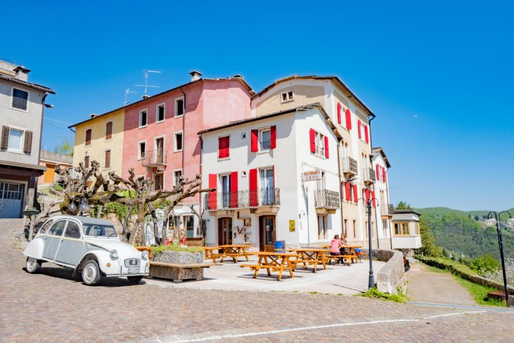 an old car parked in front of a building at Albergo Osteria Leso1815 in Bosco Chiesanuova