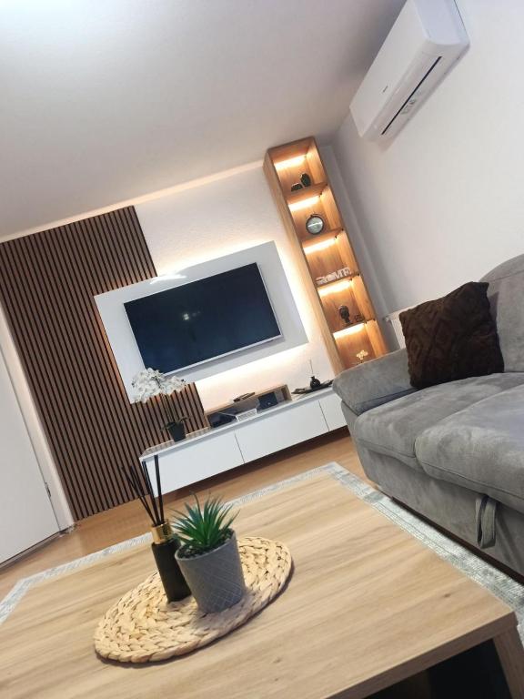 a living room with a couch and a table at Apartment Alan - Modern Stay in Travnik