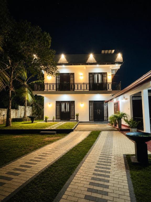 a house at night with a walkway in front of it at Janri Villa in Tangalle