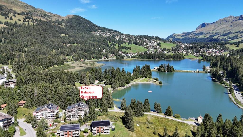an aerial view of a lake in the mountains at Belmont Seegarten in Lenzerheide
