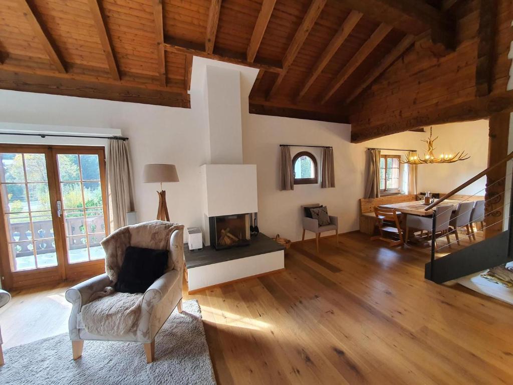 a living room with a chair and a fireplace at Ferienwohnung Selina in Lenzerheide
