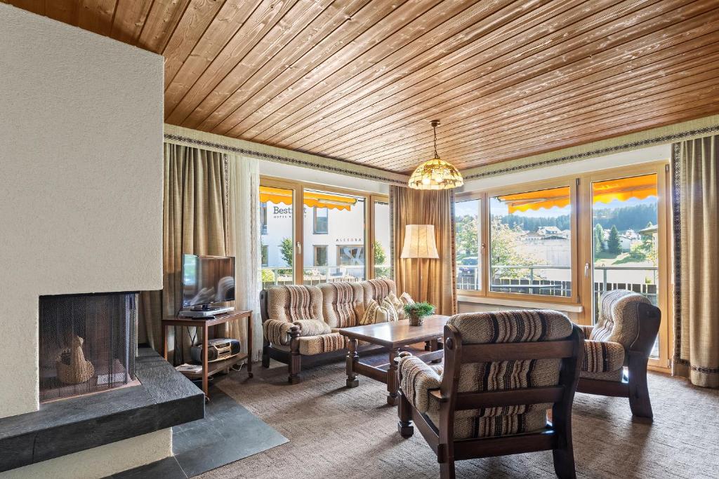 a living room with a couch and a fireplace at Triangel D Grossenberger in Parpan