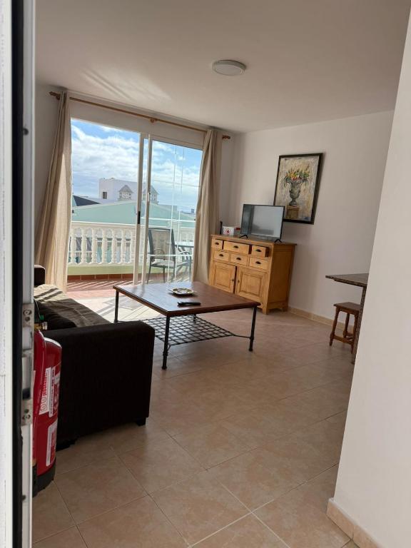 a living room with a table and a view of the ocean at VV Monica 33 "by AFCVacacional" in Puerto Naos