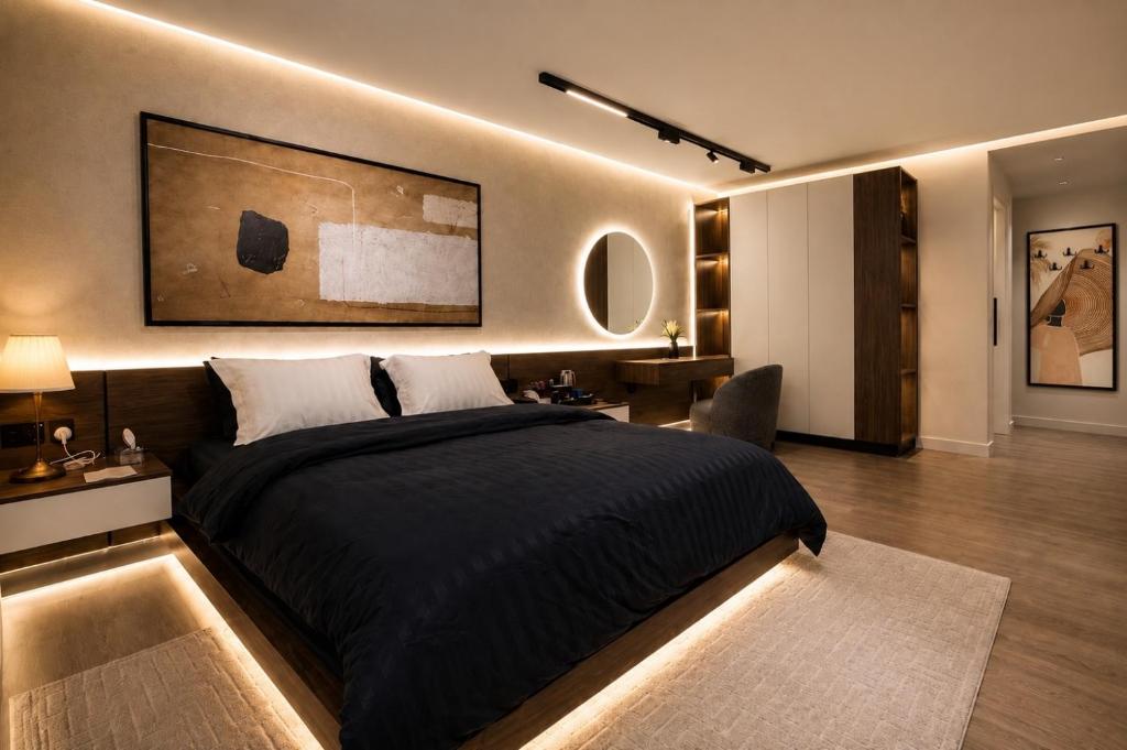 a bedroom with a large black bed and a living room at هابي رومز - شقق فندقية في الخبر in Al Khobar