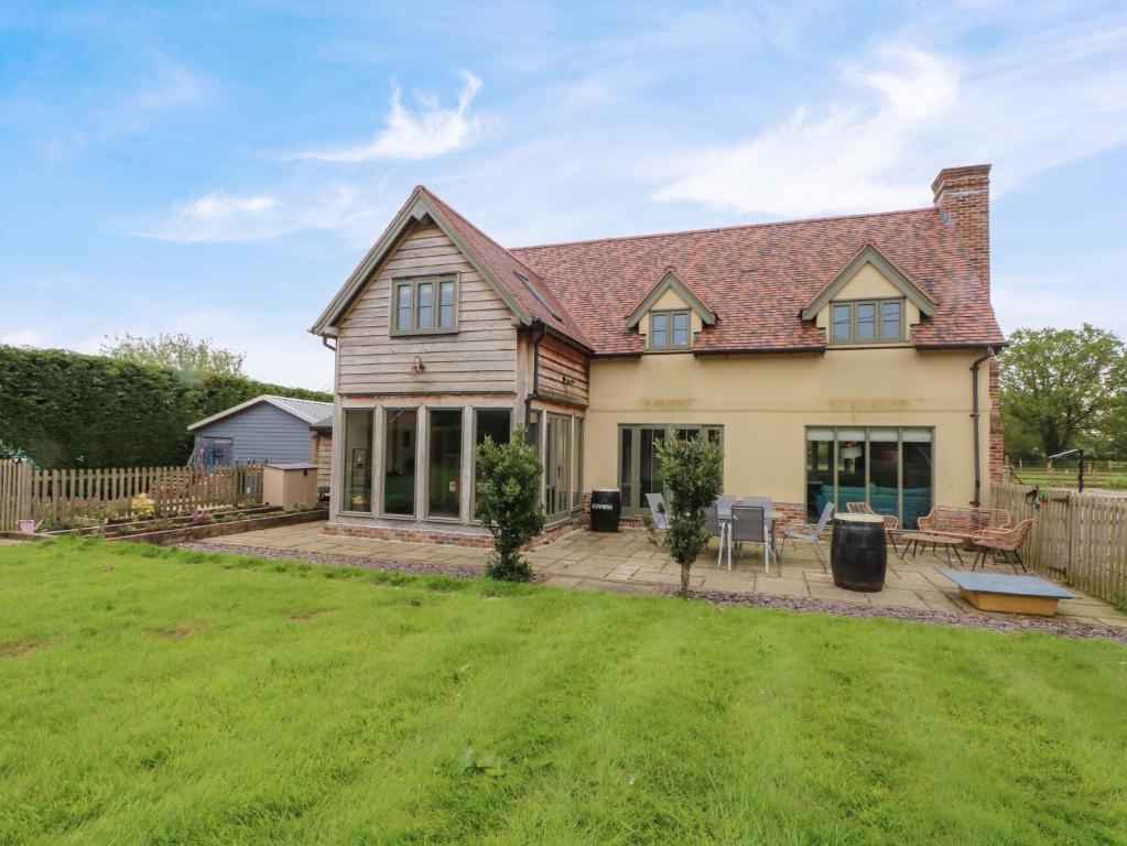 a house with a lawn in front of it at Gayton Stables in Wirral