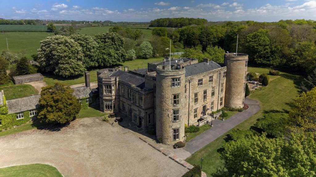 an aerial view of an old castle with trees at Walworth Castle Hotel, BW Signature Collection in Darlington