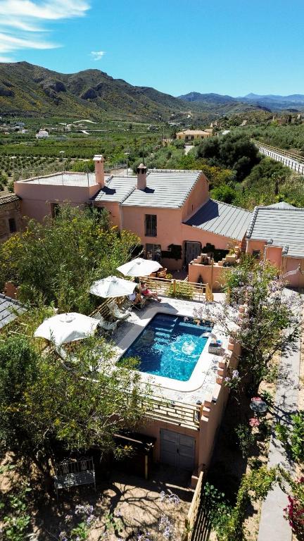 an overhead view of a resort with a pool and umbrellas at Boutique Cortijo Meliora in Cantoria