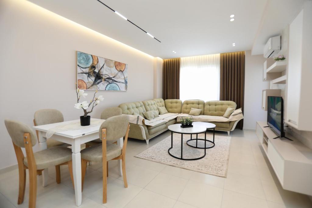 a living room with a couch and a table at Alrei Apartment in Vlorë