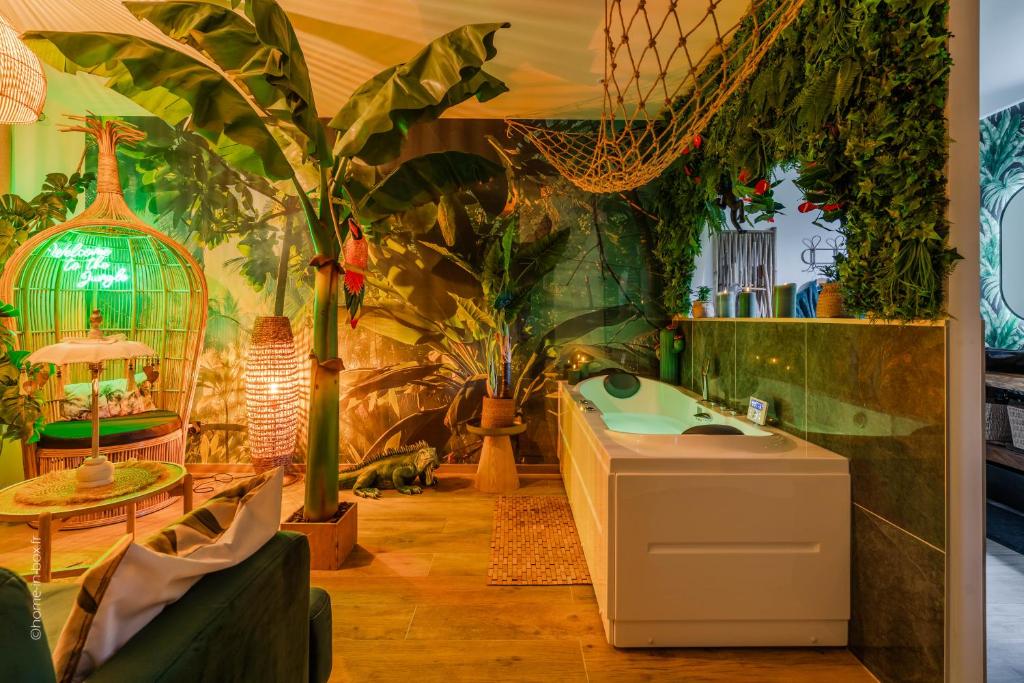 a bathroom with plants on the wall and a sink at Lodge de la Jungle avec Spa in Nanteuil-lès-Meaux